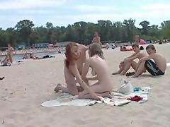 Naughty young nudists play with each other in sand
